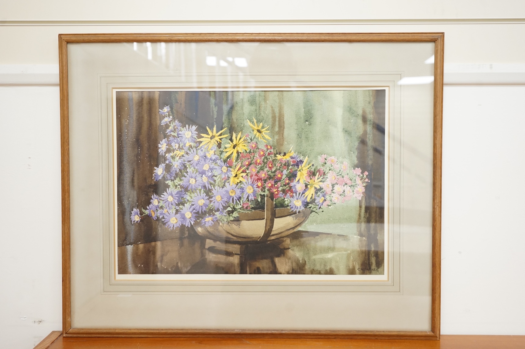 C.V. Parker (20th. C), watercolour, Still life of flowers in a trug, signed, 40 x 59cm